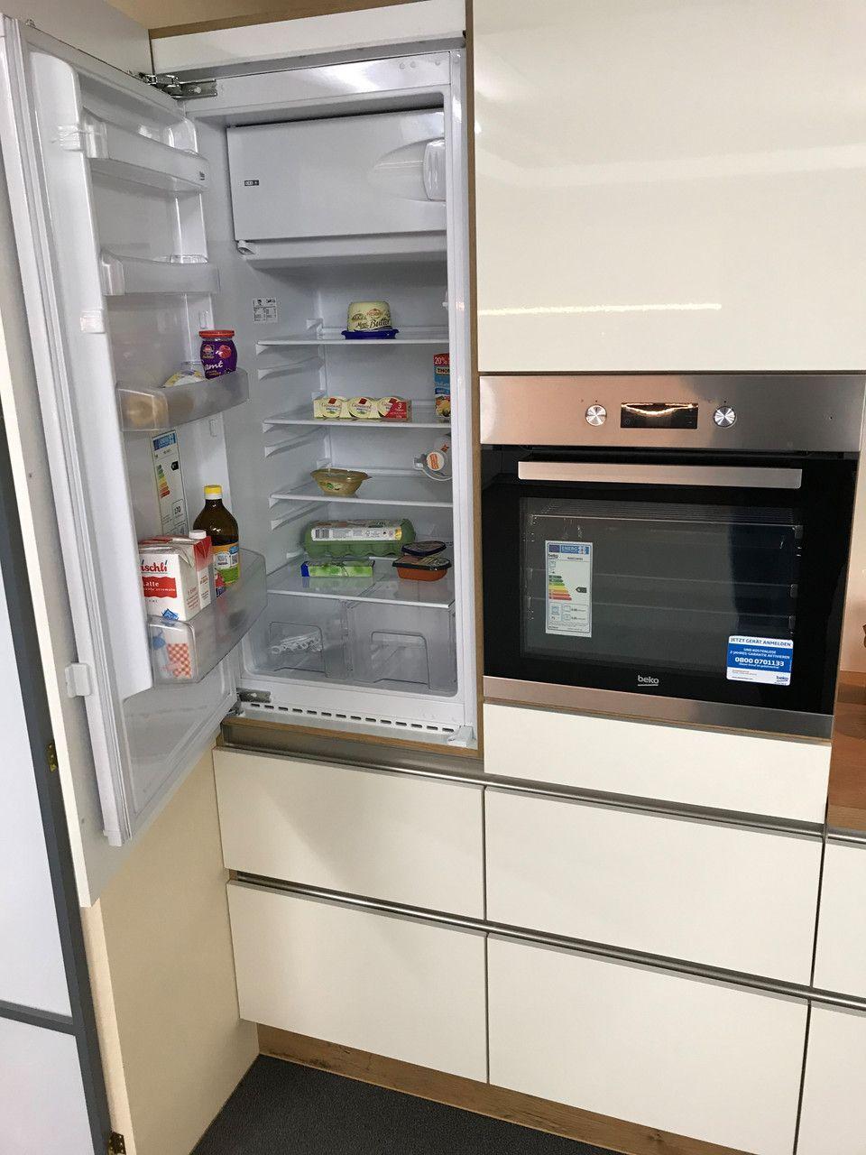 Unsere Ausstellung in Bischberg — Geöffneter Einbaukühlschrank mit Lebensmitteln neben Beko-Backofen