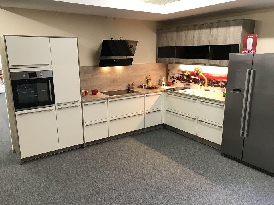 Unsere Ausstellung in Bischberg — Showroomküche mit weißen Fronten, Holz-Akzent und Side-by-Side-Kühlschrank